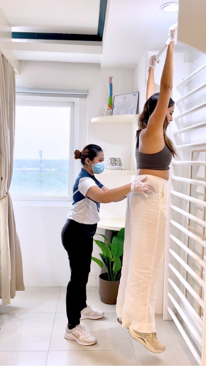 A clinician guiding a patient through Schroth-method postural correction